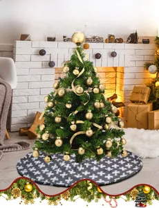 Detail of grey plush Christmas tree skirt with white snowflake patterns in cozy home setting