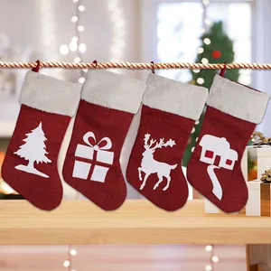 Set of four red burlap Christmas stockings with white festive silhouettes and faux fur cuffs