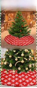 Close-up of red Christmas tree skirt featuring white jacquard snowflake patterns