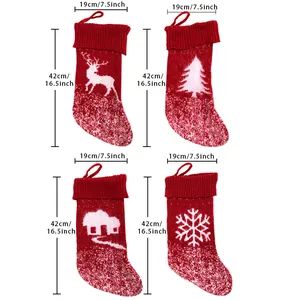 Set of four red knitted Christmas stockings with reindeer, tree, and cabin patterns