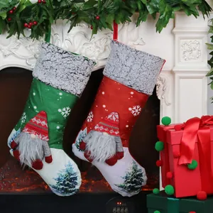 Christmas gnome stockings set with red and green embroidery hanging on a white fireplace