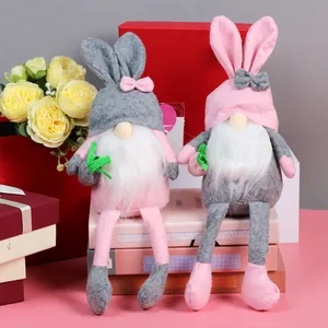 Detail of Easter gnome plush dolls with bunny ears and long legs on home decor books