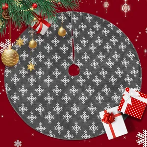 Dark grey Christmas tree skirt with white snowflake patterns on a festive red background