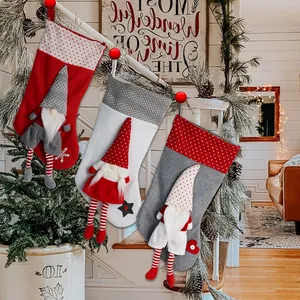 Drie kerstsokken met 3D-kabouters op de trap, rood, wit en grijs, feestelijke decoratie