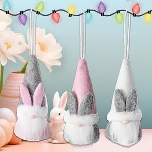 Three Easter plush gnomes with bunny ears and white beards on festive background