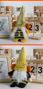 Detail of bee gnomes with sequin and crochet hats, orange wings and striped knit bodies