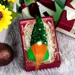 Saint Patrick's Day gnome ornament with green sequins and orange beard in a red gift box