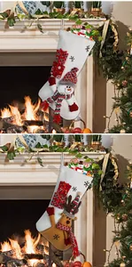 Detail of plush Christmas stockings with 3D snowman and reindeer figures by fireplace