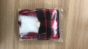 Detailed view of gnome wine bottle cover with red and black buffalo plaid hat and white beard