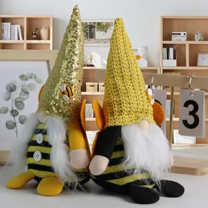 Pair of bumble bee themed gnomes with sequins and knitted hats for spring home decor