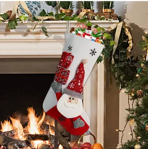 Close-up of Santa Claus Christmas stocking hanging by a fireplace with festive lighting