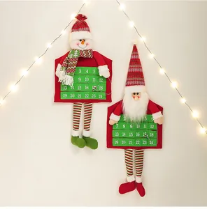 Detail of hanging Christmas countdown calendars with felt pockets and festive LED lights