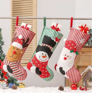 Close-up of three striped Christmas stockings with 3D reindeer, snowman and Santa appliques
