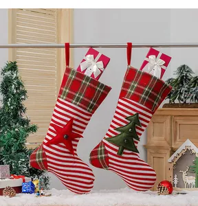 Detail of knitted Christmas stockings with star and tree patches on cozy holiday background