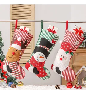 Detailed view of plush Christmas stockings featuring 3D elk, snowman and Santa appliques