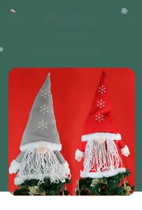 Detail of red and grey knitted gnome Christmas tree toppers with white snowflake patterns