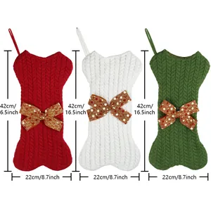 Three large knit bone-shaped Christmas stockings in red, white, and green holiday colors