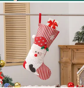 Detail of plush Christmas stocking with Santa Claus 3D figure hanging as festive decor