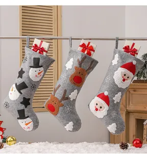 Three grey felt Christmas stockings with Santa, reindeer and snowman embroidery details