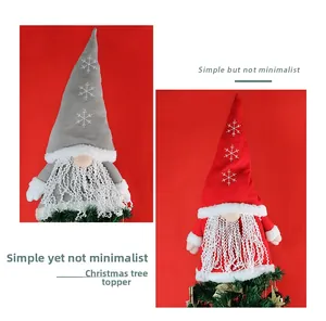Close-up of red and grey knitted gnome Christmas tree toppers with snowflake embroidery