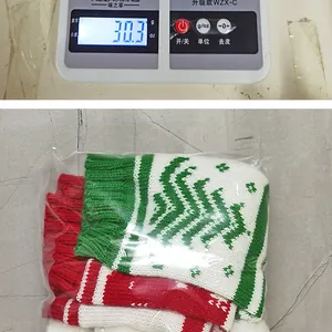 Knitted Christmas wine bottle cover with red, white and green patterns weighing 30.3g