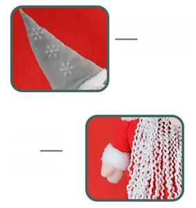 Detail of Christmas gnome with grey snowflake knit hat and red suit on red background