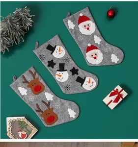 Detail showing grey felt Christmas stockings with Santa, Snowman and Reindeer motifs