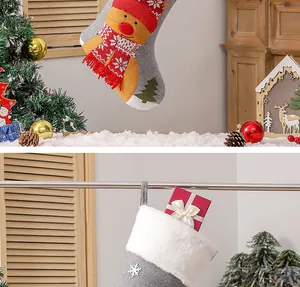 Detail of Christmas stocking decorations featuring reindeer patchwork and white plush cuff