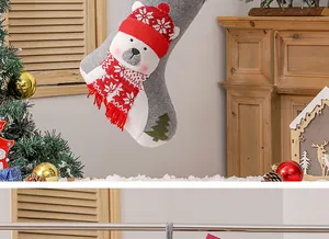 Detail of grey felt Christmas stocking with 3D polar bear and knit scarf ornament