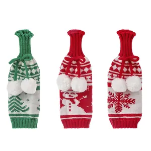 Three knitted Christmas wine bottle covers featuring snowman and snowflake patterns