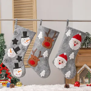 Three-piece set of grey Christmas stockings featuring snowman elk and Santa hanging decor