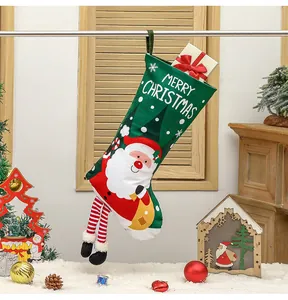 Detail of green Christmas stocking with Santa Claus design and striped legs on wooden table