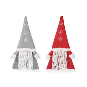 Handcrafted Nordic Christmas gnome tree toppers with knitted hats in red and grey