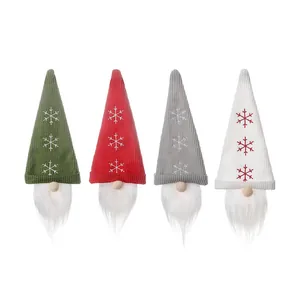 Set of four Christmas gnome wine bottle covers with snowflake knitting in red, green, and grey