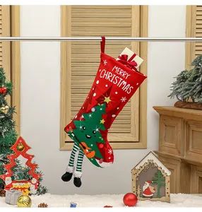 Detail of red Christmas stocking with cartoon tree playing guitar and long striped legs