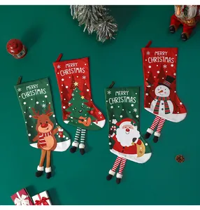 Set of 4 Christmas stockings with reindeer and Santa designs on a green wall background