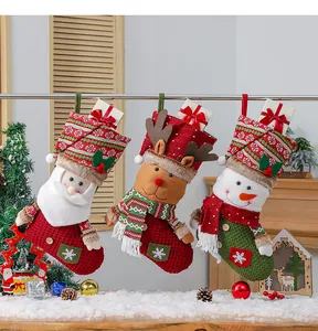 Close-up of three knitted Christmas stockings featuring Santa, Snowman and Reindeer details