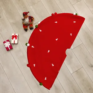 Red Christmas tree skirt with white embroidered trees and festive pom pom edges