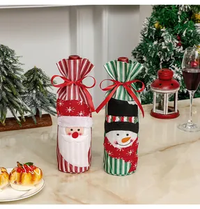 Detail of Christmas wine bottle covers featuring Santa and Snowman embroidery and ribbons