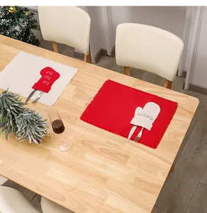 Close-up of linen Christmas placemats with festive stocking and glove cutlery holders