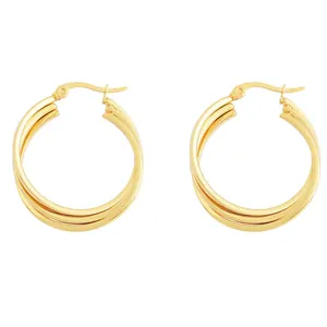 Detail view of triple layered gold hoop earrings with polished spiral interlocking design