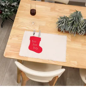 Linen Christmas placemat with red stocking cutlery holder and Ho Ho Ho text detail