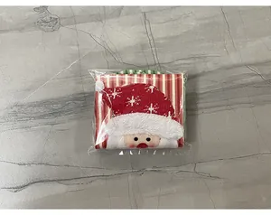 Detail of Christmas wine bottle cover featuring embroidered Santa on striped fabric