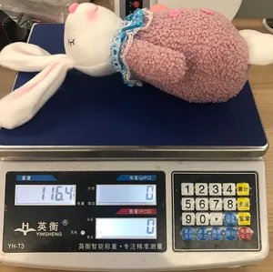 Detail shot showing a 116.4g plush Easter bunny toy on an electronic weighing scale