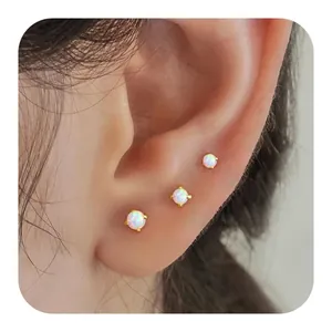 Three-piece gold plated opal stud earring set featuring round polished stones in four-prong settings
