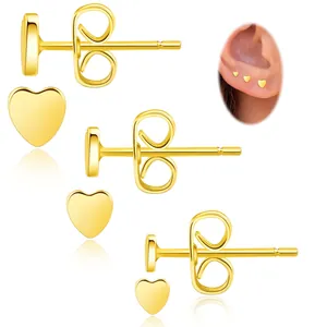 Detailed set of three gold heart earrings in various sizes with model wearing reference