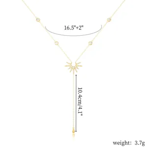 Gold Y-shaped tassel necklace with star pendant and crystal details on white background