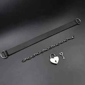 Detail of gold-plated brass Cuban chain with heart padlock and key set in punk style