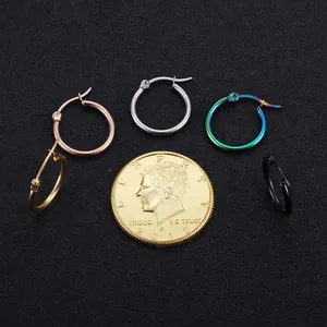 Five pairs of minimalist brass hoop earrings in various colors displayed on a black background