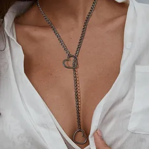 Detail of dark grey adjustable Y-lariat necklace with hollow heart pendants on model
